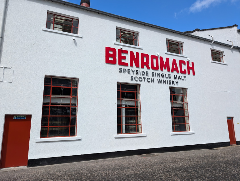 The Benromach distillery building with its red Benromach lettering.